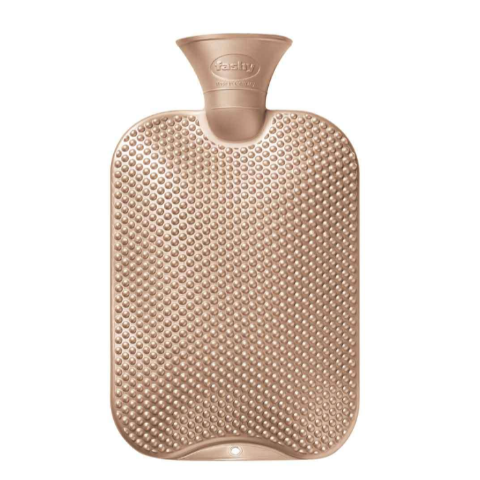 Gold hot water bottle with textured surface on a white background